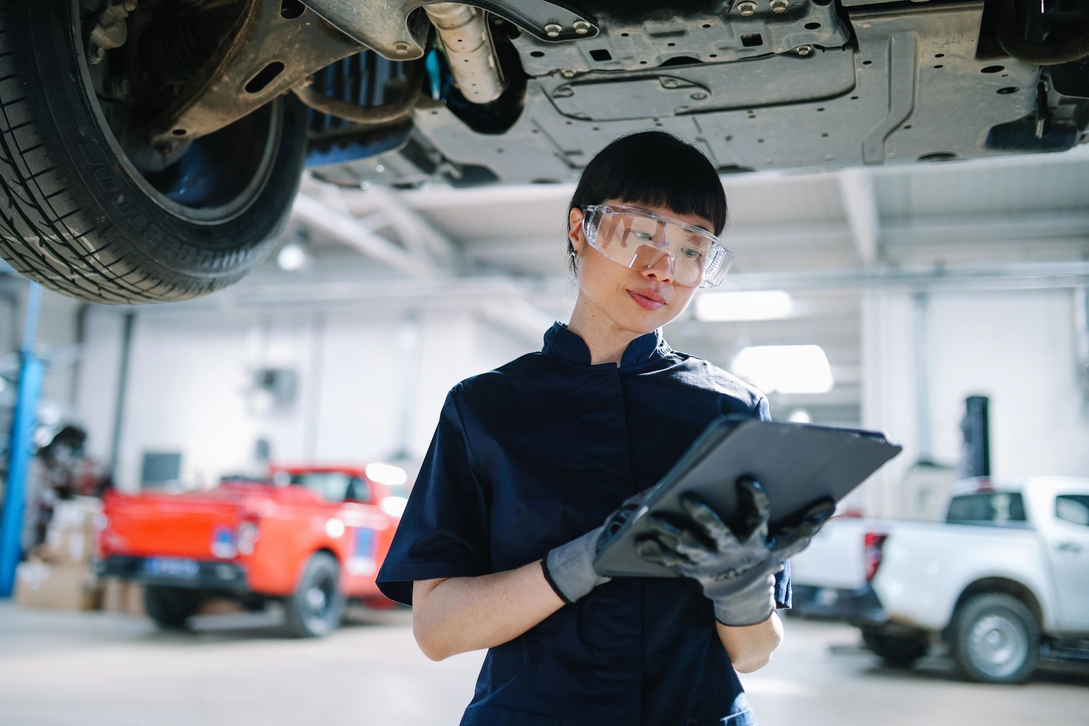 Technician using a tablet for EV diagnostics on the Gold Coast